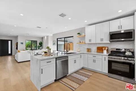 a kitchen with a sink stove and microwave