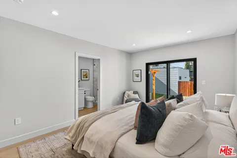 a bedroom with a large bed and a large window