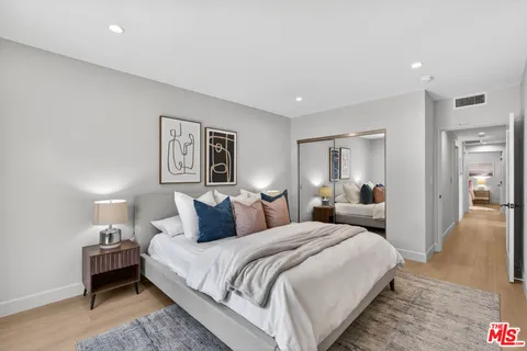 a bedroom with a bed and a mirror