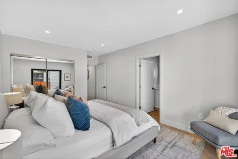 a bedroom with a bed and a couch