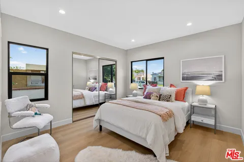 a bedroom with a bed and wooden floor