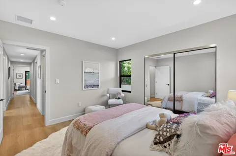 a bedroom with two beds and a chandelier