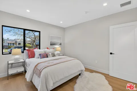 a bedroom with a large bed and a large window