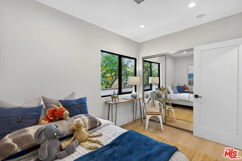a bedroom with furniture and a wooden floor