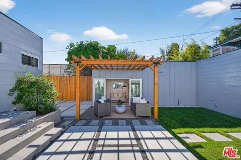 a view of a patio with couches and potted plants