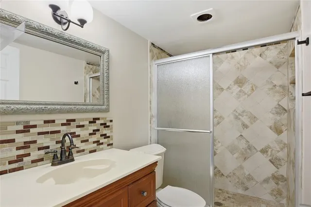 a bathroom with a sink toilet and shower