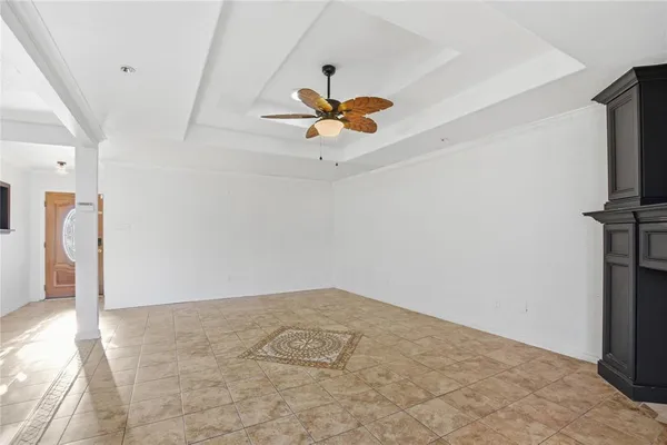a view of a room with a ceiling fan and a window