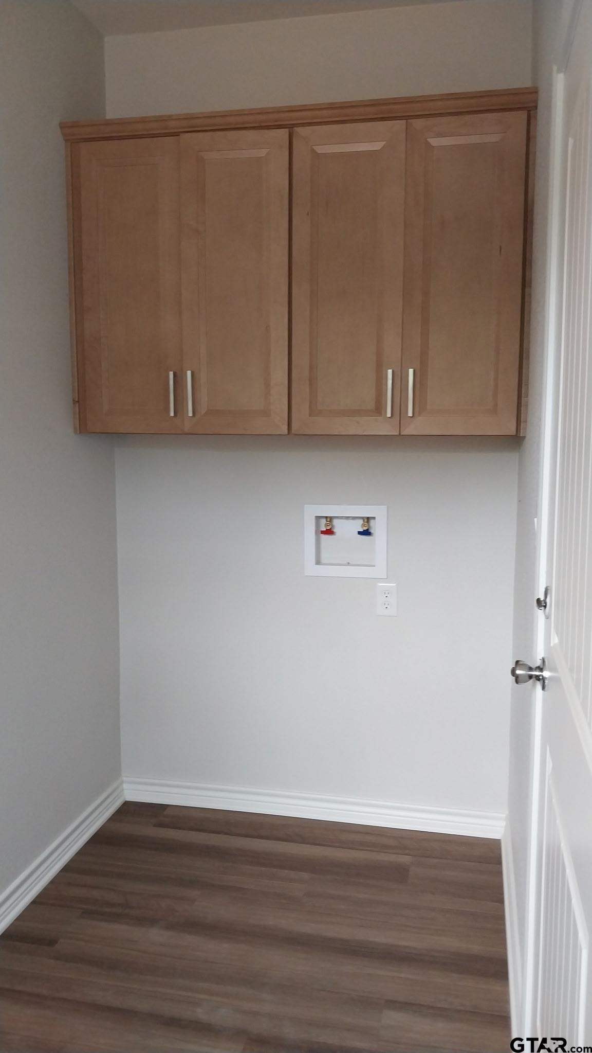 1262 George Richey Road Gladewater, TX 75647 - Photo 19 of 22 a view of room with wooden floor and cabinet