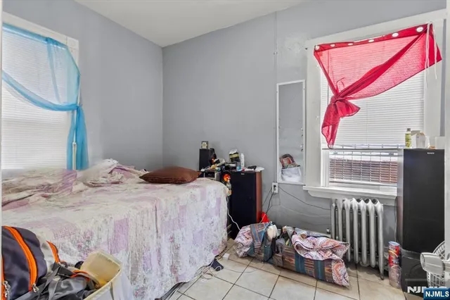 a bedroom with a bed closet and a mirror