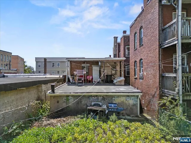 a view of a water with building and car parked