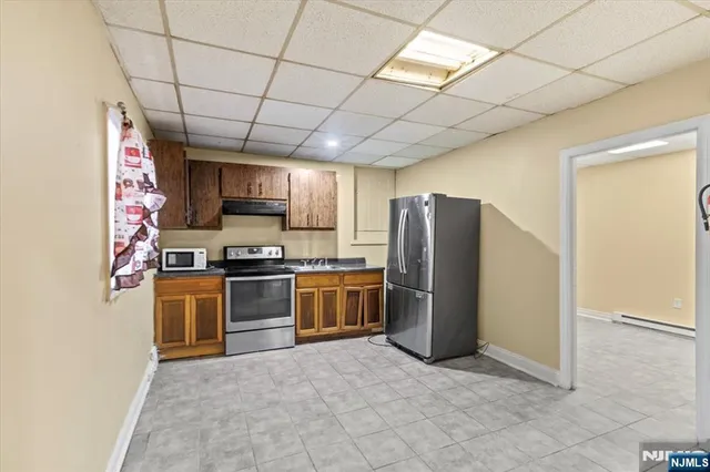 a kitchen with stainless steel appliances granite countertop a refrigerator stove and sink