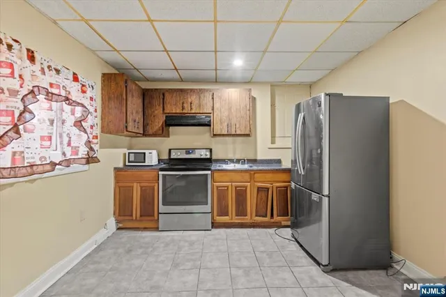 a kitchen with stainless steel appliances granite countertop a refrigerator and a stove