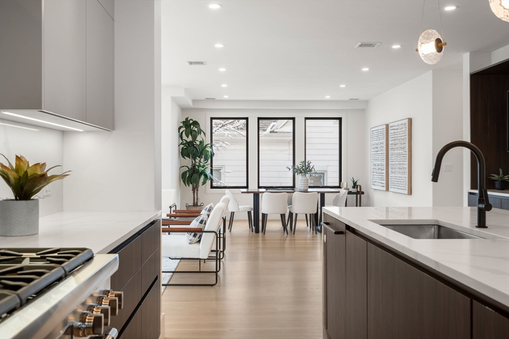 116 Thorndike Street, Unit 2B Brookline, MA 02446 - Photo 18 of 33 a kitchen with granite countertop lots of counter top space and dining table