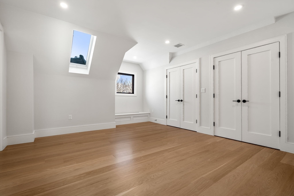 116 Thorndike Street, Unit 2B Brookline, MA 02446 - Photo 21 of 33 a view of an empty room with wooden floor