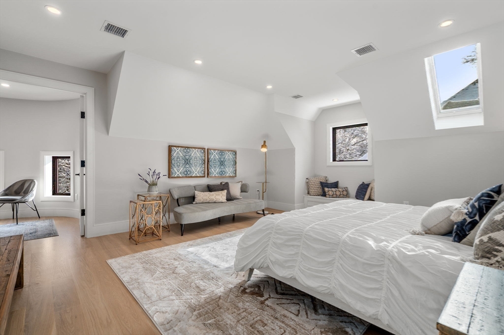 116 Thorndike Street, Unit 2B Brookline, MA 02446 - Photo 25 of 33 a spacious bedroom with a bed and wooden floor