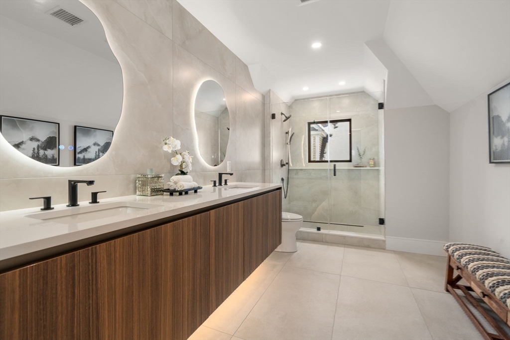 116 Thorndike Street, Unit 2B Brookline, MA 02446 - Photo 26 of 33 a bathroom with double vanity sinks and a mirror