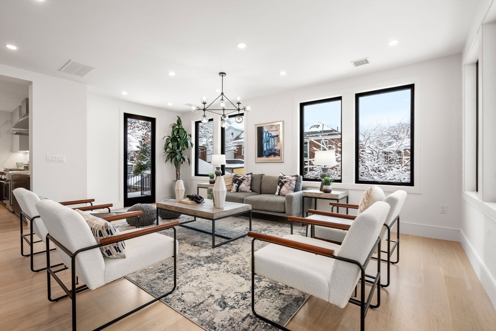116 Thorndike Street, Unit 2B Brookline, MA 02446 - Photo 3 of 33 a living room with furniture and a large window