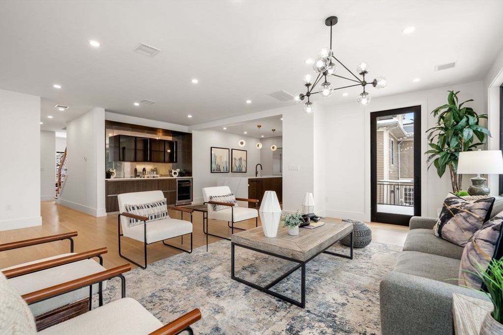 116 Thorndike Street, Unit 2B Brookline, MA 02446 - Photo 6 of 33 a living room with furniture and a chandelier