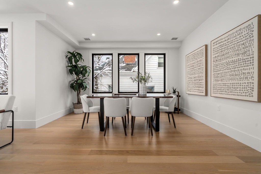 116 Thorndike Street, Unit 2B Brookline, MA 02446 - Photo 8 of 33 a dining room with furniture large windows and wooden floor
