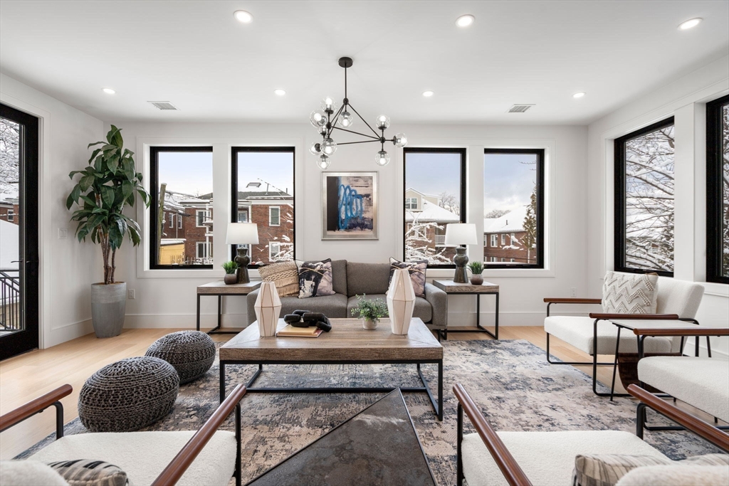 116 Thorndike Street, Unit 2B Brookline, MA 02446 - Photo 9 of 33 a living room with furniture potted plant and a window