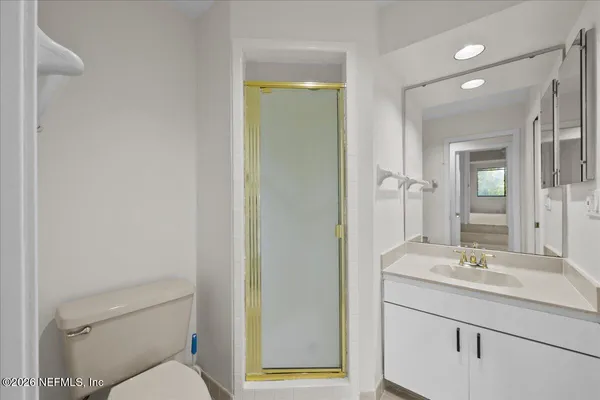 a bathroom with a sink mirror vanity and toilet
