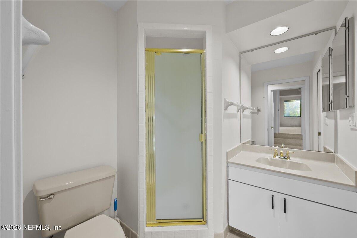 2990 Ravines Road, Unit 1422 Middleburg, FL 32068 - Photo 14 of 20 a bathroom with a sink mirror vanity and toilet