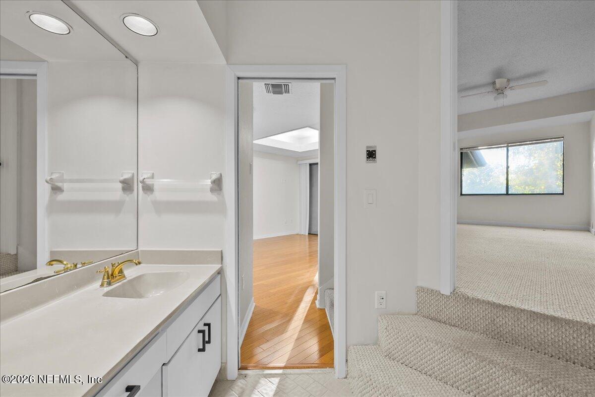 2990 Ravines Road, Unit 1422 Middleburg, FL 32068 - Photo 15 of 20 a bathroom with a tub sink and mirror