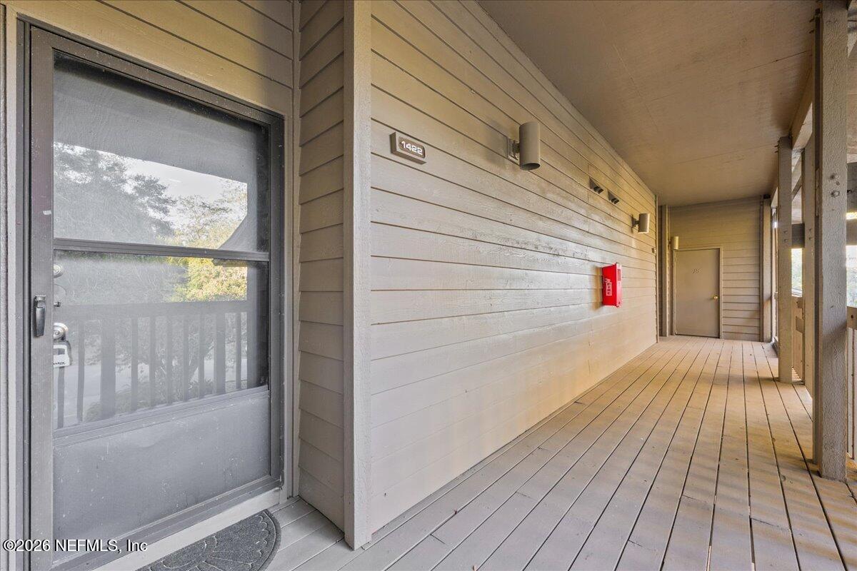2990 Ravines Road, Unit 1422 Middleburg, FL 32068 - Photo 2 of 20 a view of a balcony with wooden floor