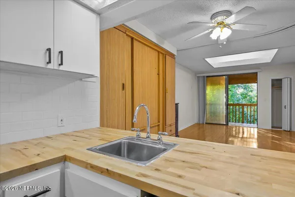 a kitchen with a stove a sink and a window