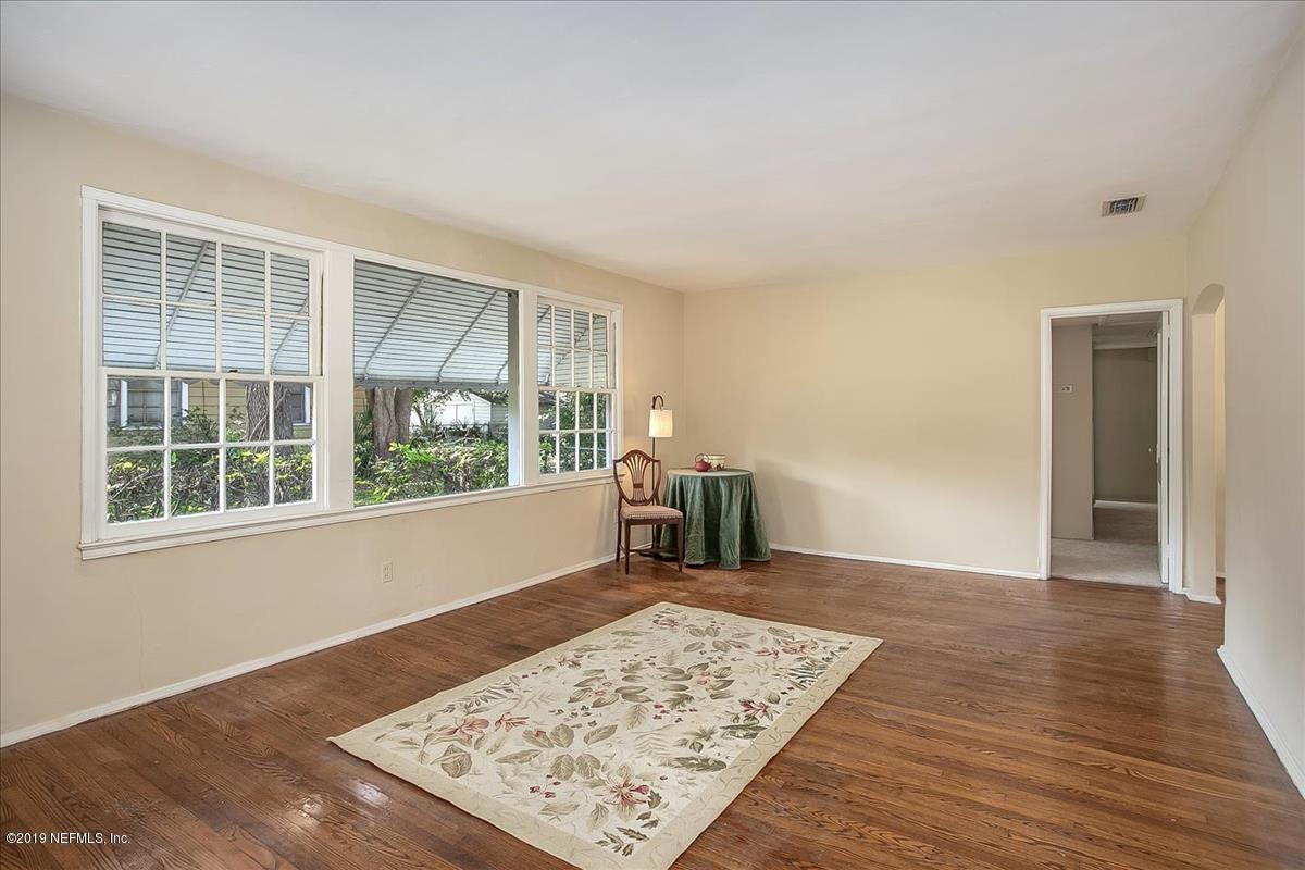1742 Planters Road Jacksonville, FL 32207 - Photo 4 of 18 an empty room with wooden floor and a window