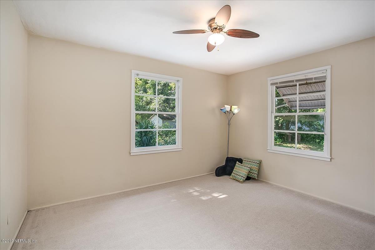 1742 Planters Road Jacksonville, FL 32207 - Photo 10 of 18 an empty room with a window and a ceiling fan