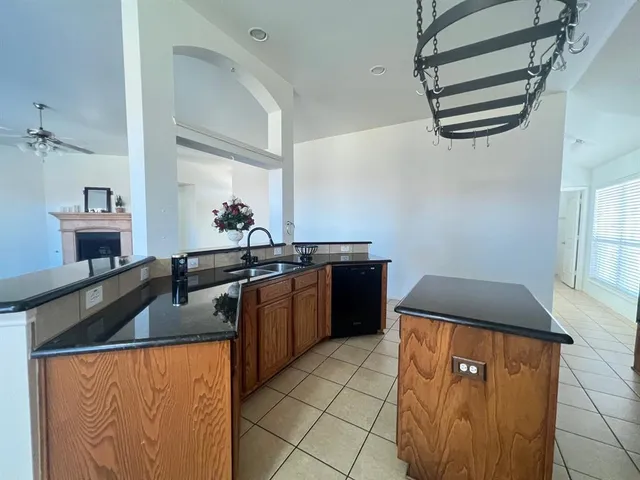 a kitchen with stainless steel appliances granite countertop a sink and a refrigerator