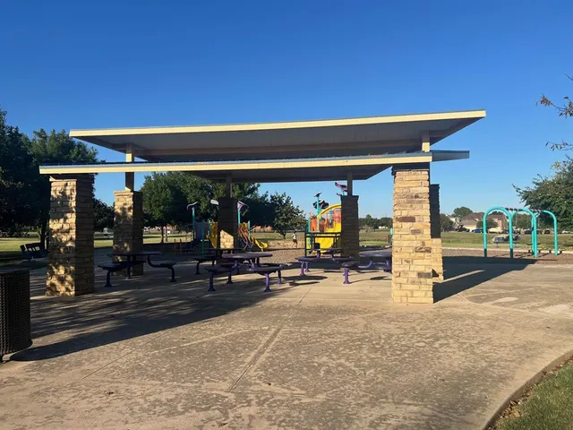 a view of a patio with a table and chairs under an umbrella