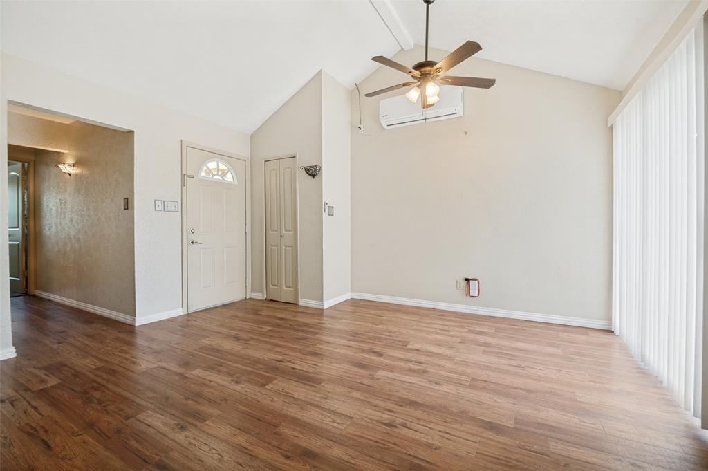 7305 Pineberry Road Dallas, TX 75249 - Photo 8 of 25 a view of an empty room with wooden floor