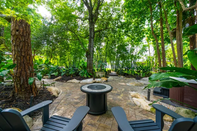 a view of backyard with outdoor seating and green space