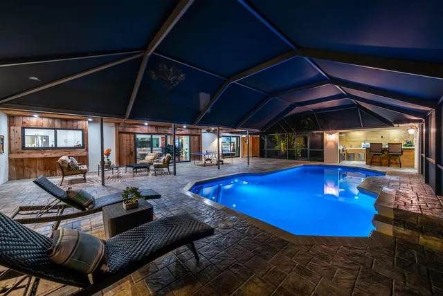 a view of swimming pool with seating area