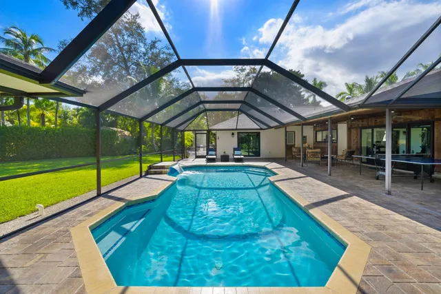 a view of swimming pool with chairs