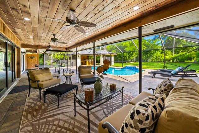 a patio with swimming pool table and chairs