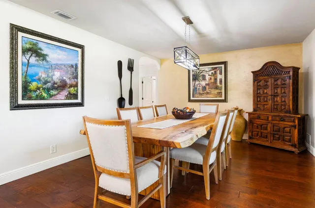 a bedroom with a large bed and a large window with wooden floor