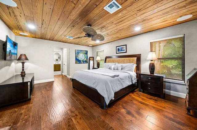a bathroom with a double vanity sink mirror and bathtub