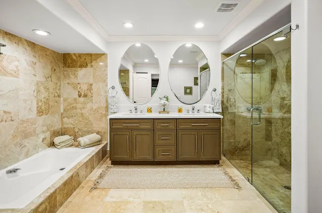 a bedroom with a bed a table and a bookshelf with wooden floor