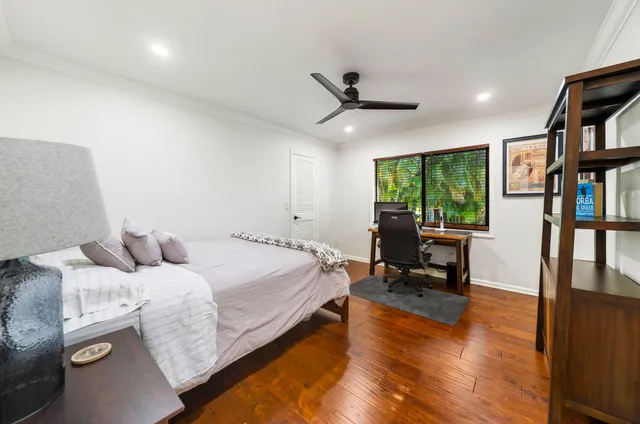 a spacious bathroom with a toilet a sink and a mirror