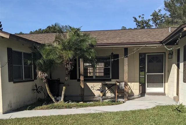 a view of a chair and table in front of house