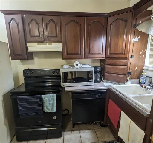 a bathroom with a granite countertop sink a toilet and mirror
