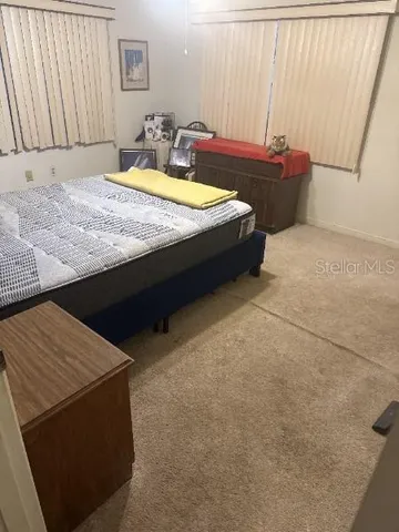 a spacious bathroom with a granite countertop sink and a mirror