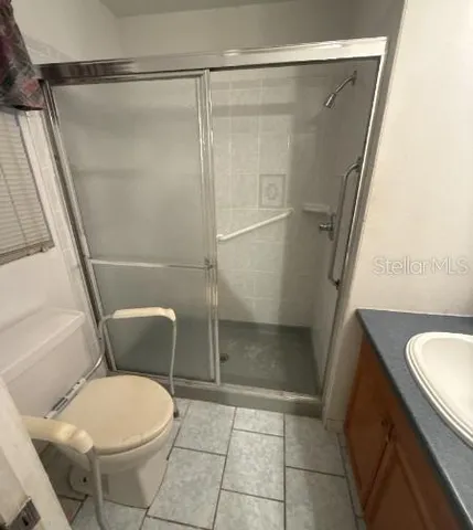 a bathroom with a toilet and a shower