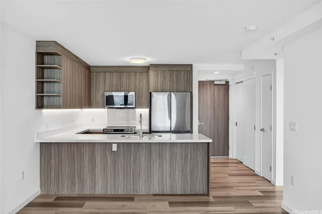 a kitchen with granite countertop a stove and a refrigerator