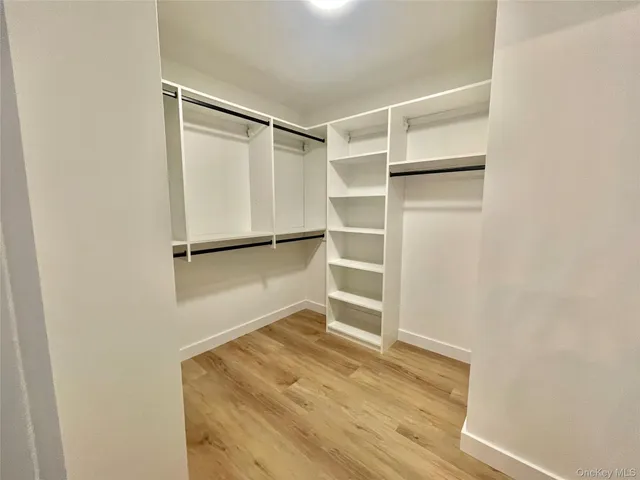 a view of walk in closet with empty racks