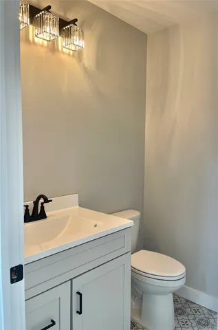 a bathroom with a sink a toilet and mirror