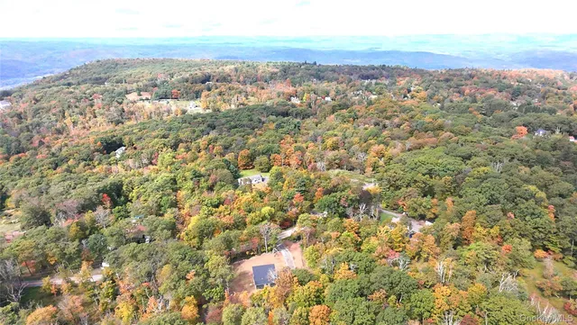 an aerial view of residential houses with city view and mountain view in back